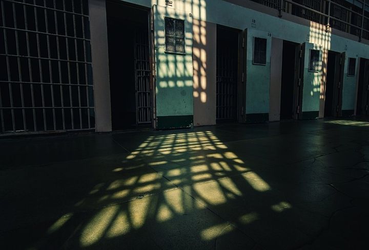Empty jail cell with light shining through the window